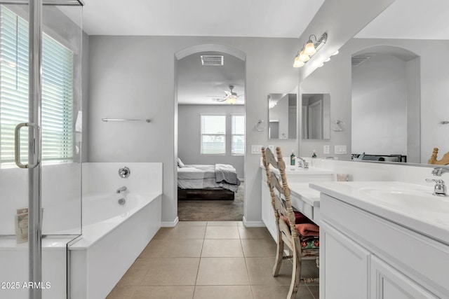 bathroom with a tub to relax in, ceiling fan, tile patterned floors, and vanity