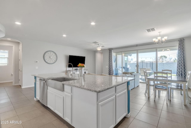 kitchen featuring sink, dishwasher, plenty of natural light, an island with sink, and white cabinets