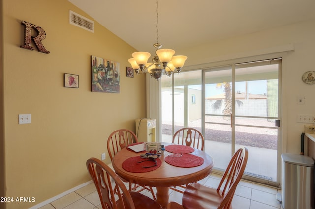 dining space featuring light tile patterned flooring, vaulted ceiling, and a chandelier