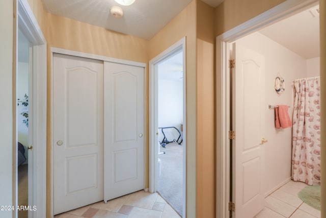 hallway featuring light carpet