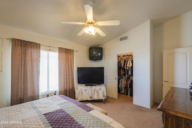 carpeted bedroom with a closet, ceiling fan, and vaulted ceiling