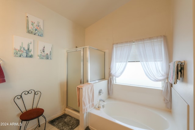 bathroom with lofted ceiling, plus walk in shower, and tile patterned floors