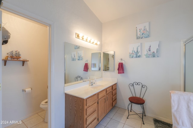 bathroom featuring walk in shower, vanity, toilet, and tile patterned floors