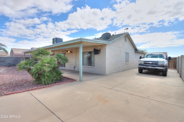 view of side of home with a patio area and ceiling fan