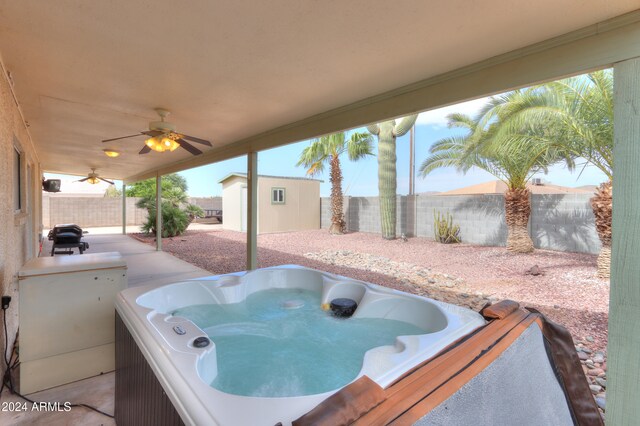 view of patio / terrace with a hot tub and ceiling fan