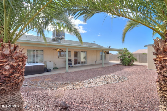 rear view of house featuring a patio, a hot tub, and ceiling fan