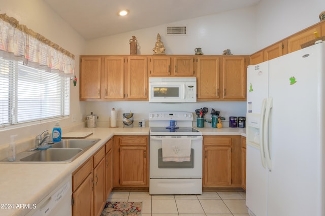 kitchen featuring white appliances, light tile patterned floors, lofted ceiling, and sink