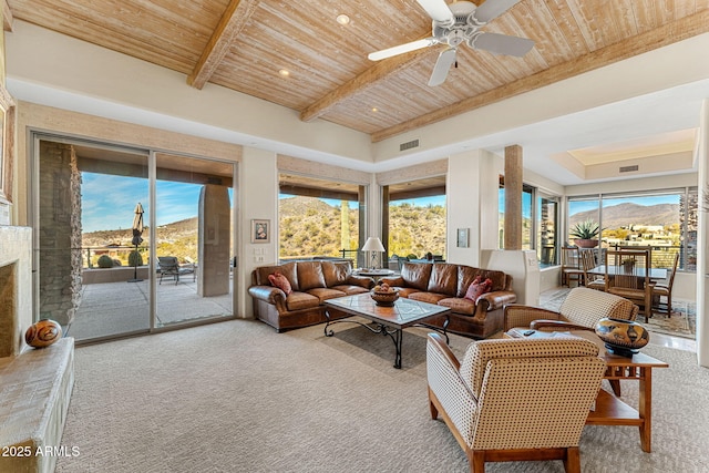 living room with visible vents, beamed ceiling, wooden ceiling, and a mountain view