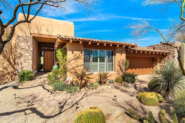 pueblo revival-style home with stucco siding