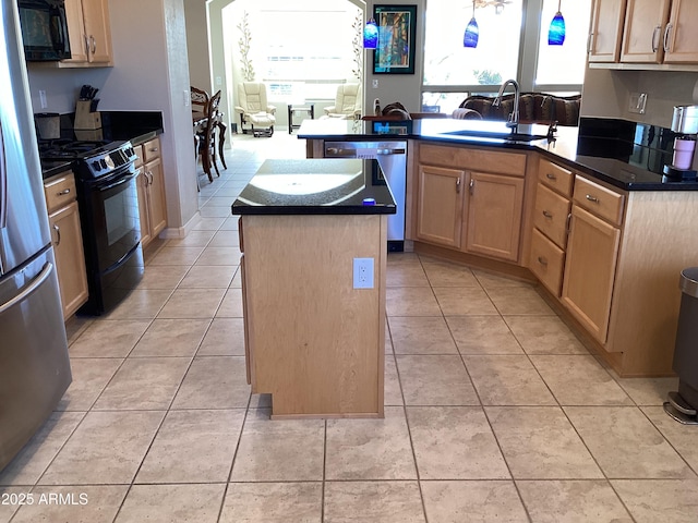 kitchen featuring a center island with sink, black appliances, sink, light tile patterned floors, and light brown cabinetry