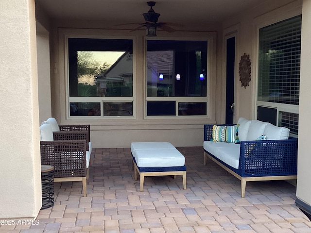 view of patio with ceiling fan and an outdoor living space