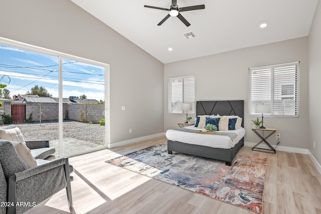 living room with ceiling fan, lofted ceiling, and light wood-type flooring