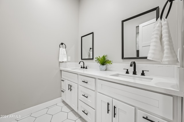 bathroom featuring dual bowl vanity and tile flooring