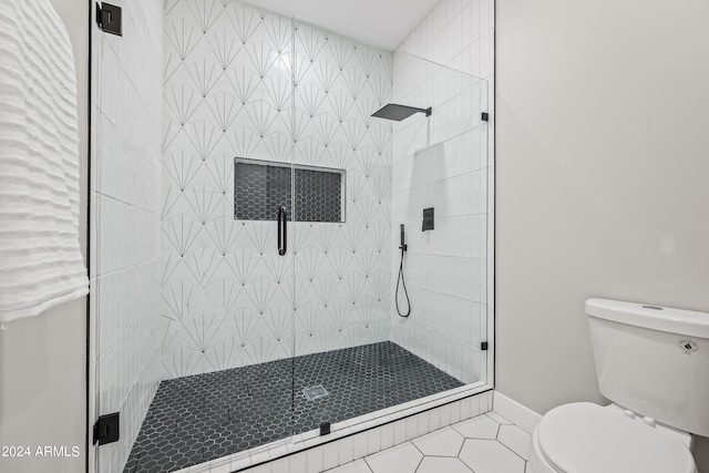 bathroom with tile floors, an enclosed shower, and toilet