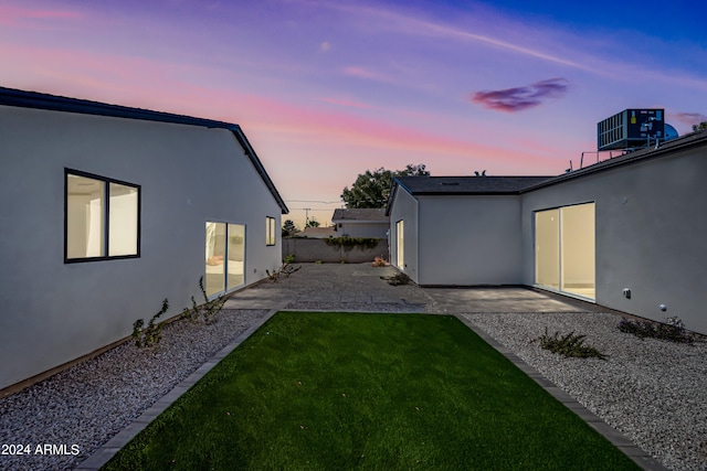 yard at dusk with a patio