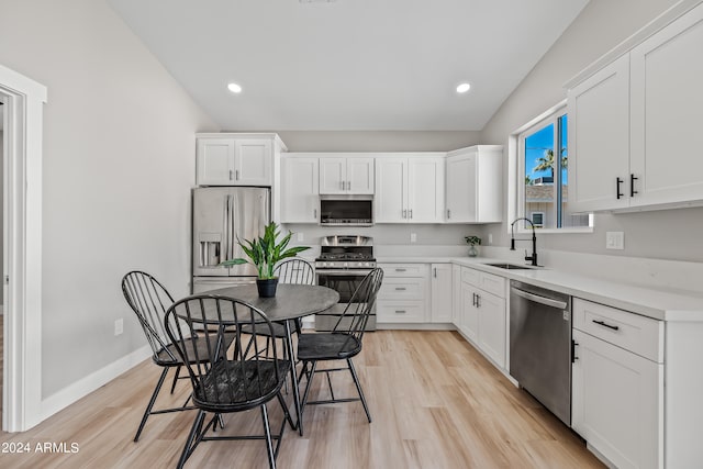 kitchen with white cabinetry, sink, light wood-type flooring, and stainless steel appliances