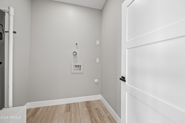 laundry room with hookup for a washing machine, light hardwood / wood-style floors, and hookup for a gas dryer