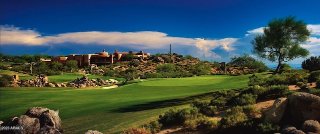 view of property's community featuring golf course view and a yard