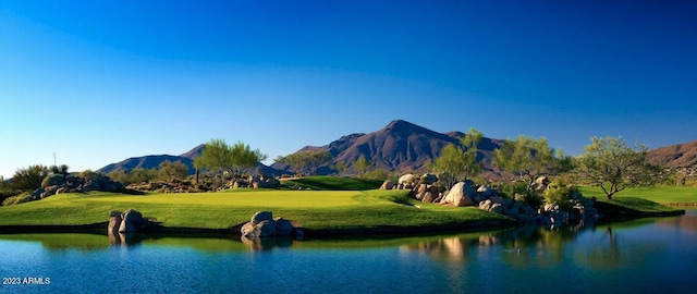 surrounding community featuring a yard and a water and mountain view