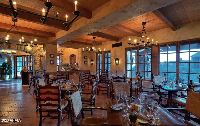 dining room featuring beamed ceiling, a chandelier, wooden ceiling, and french doors