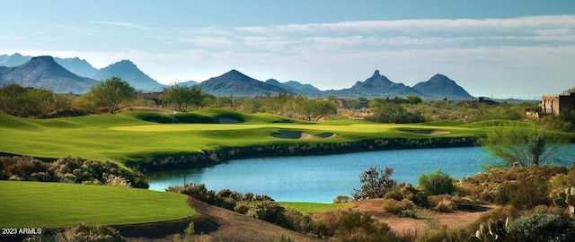 view of community with a yard, golf course view, and a water and mountain view