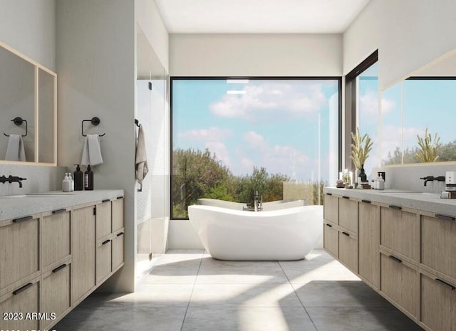 bathroom with a freestanding bath, two vanities, plenty of natural light, and a sink