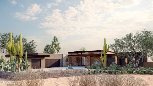 view of front of house featuring stucco siding, stone siding, and an attached garage