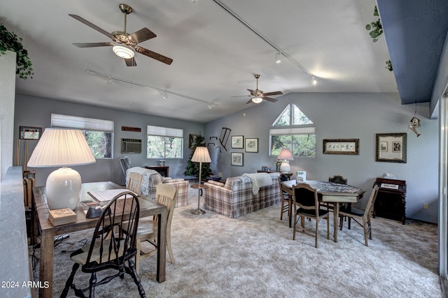 carpeted dining area featuring lofted ceiling, ceiling fan, and rail lighting