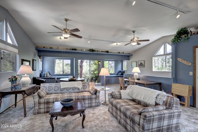 living room featuring a wealth of natural light, ceiling fan, light colored carpet, and lofted ceiling