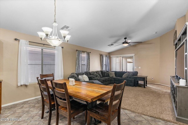 tiled dining space featuring ceiling fan with notable chandelier and lofted ceiling