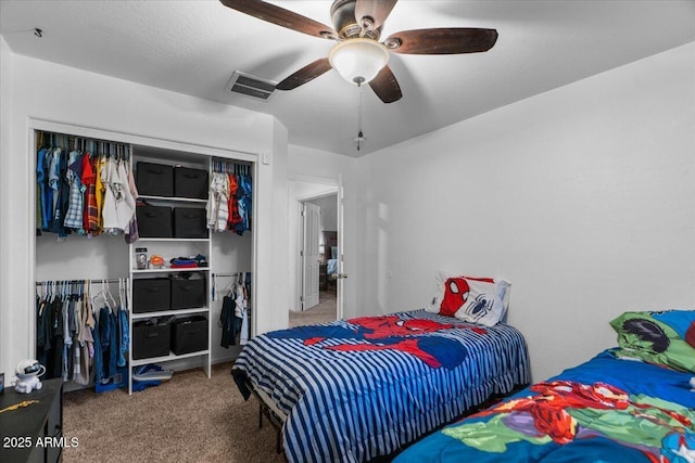 carpeted bedroom featuring a closet and ceiling fan