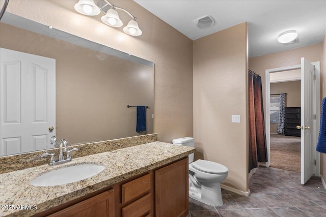 bathroom featuring toilet and vanity