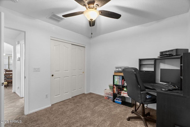 carpeted home office with ceiling fan