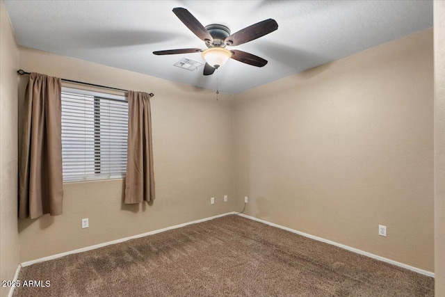 carpeted spare room with ceiling fan