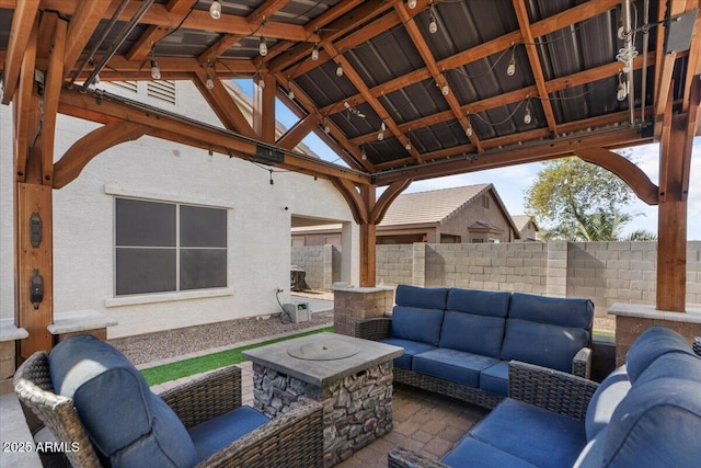 view of patio featuring a gazebo and an outdoor living space with a fire pit