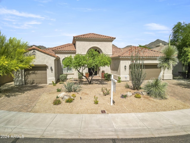 mediterranean / spanish-style home with a garage