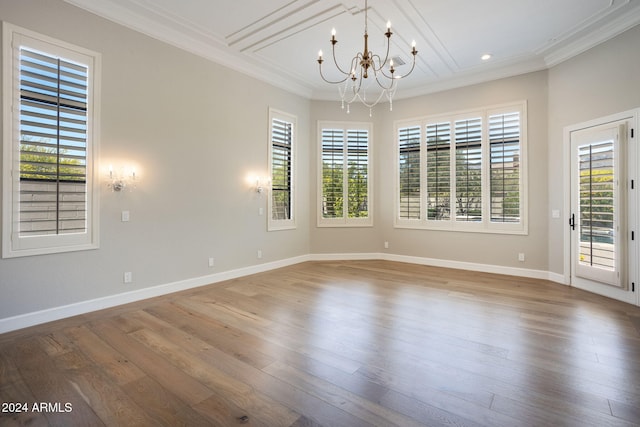 unfurnished room featuring a wealth of natural light and hardwood / wood-style floors