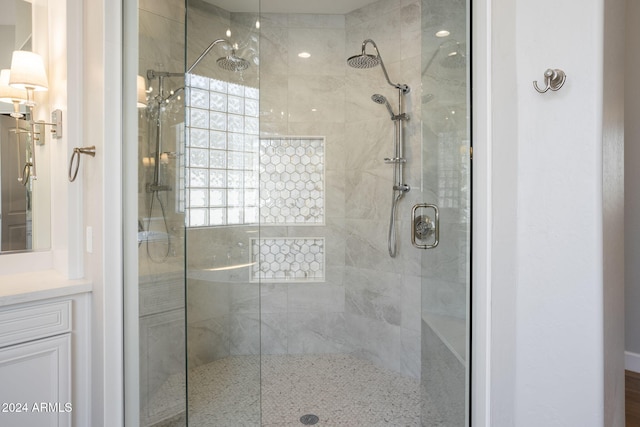 bathroom featuring vanity and a shower with door