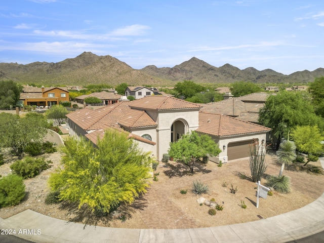 view of front of property featuring a mountain view and a garage