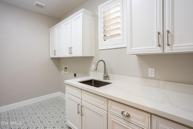 clothes washing area featuring cabinets, washer hookup, electric dryer hookup, and sink