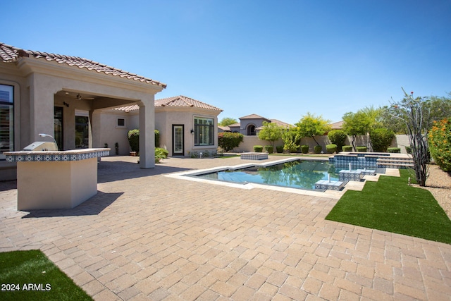 view of swimming pool featuring a patio area and an in ground hot tub