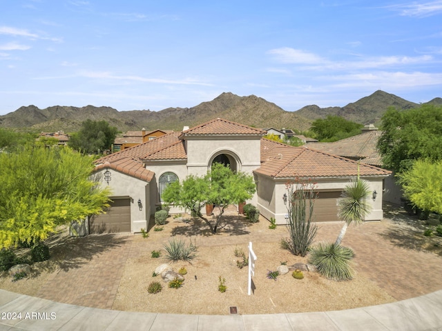 mediterranean / spanish house featuring a mountain view and a garage