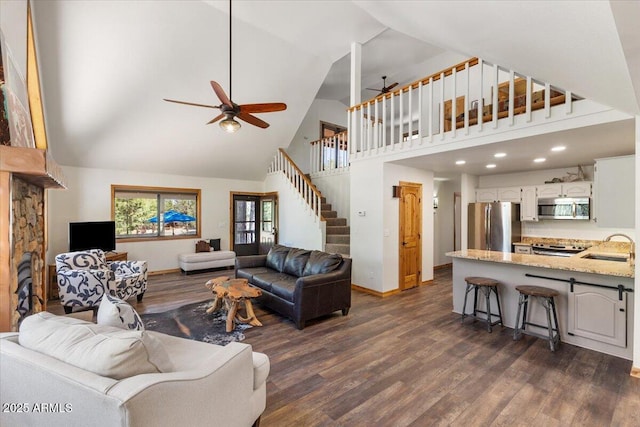 4170 Apache Dr, Happy Jack, AZ 86024 - living area featuring high vaulted ceiling, ceiling fan, dark wood finished floors, baseboards, and stairs