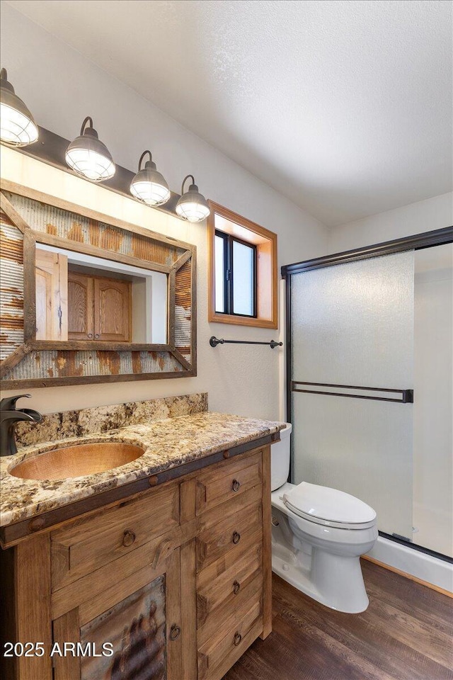 4170 Apache Dr, Happy Jack, AZ 86024 - bathroom with wood finished floors, vanity, toilet, and a shower stall