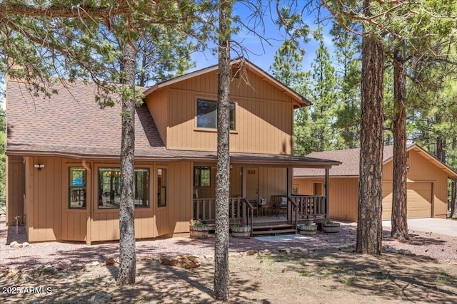 4170 Apache Dr, Happy Jack, AZ 86024 - back of property featuring roof with shingles, covered porch, a garage, and driveway