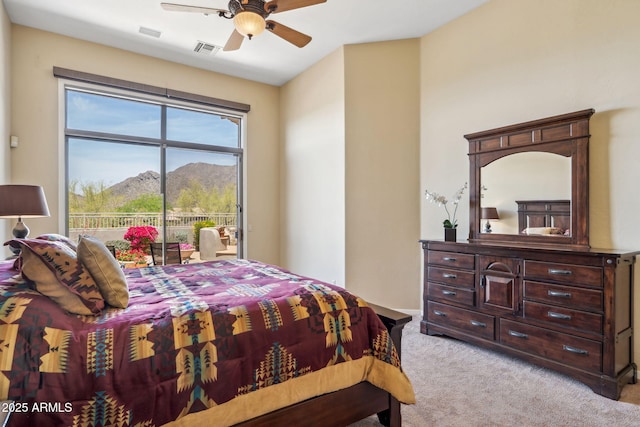 bedroom featuring a mountain view, light carpet, visible vents, ceiling fan, and access to outside