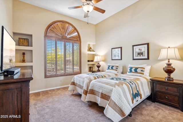 carpeted bedroom featuring baseboards and ceiling fan
