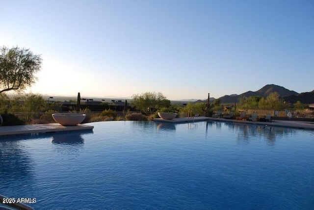 pool at dusk with a community pool