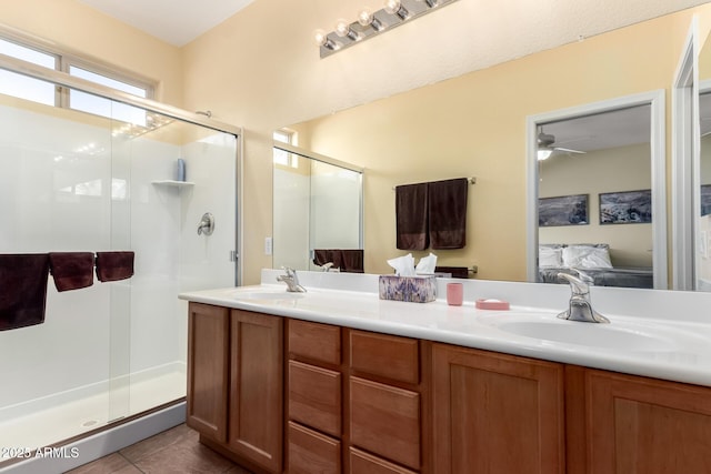 bathroom with tile patterned floors, vanity, and an enclosed shower