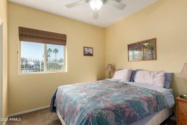 bedroom with ceiling fan and carpet floors